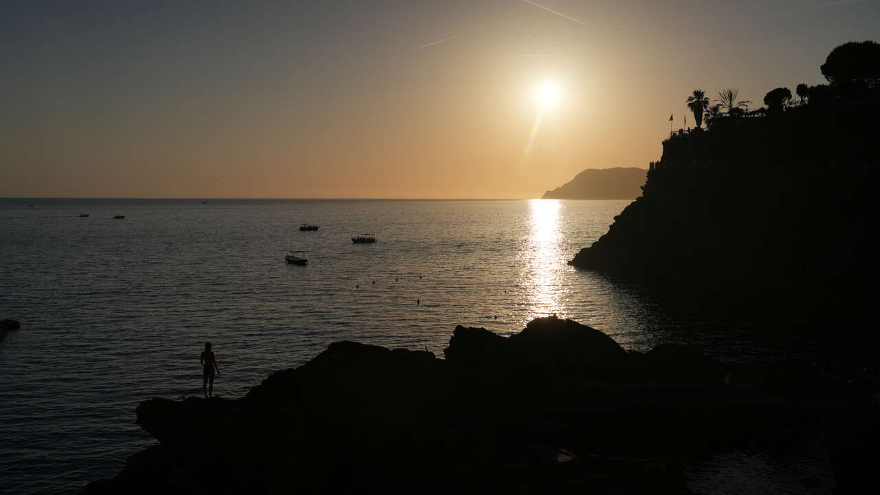 Silhouette face au soleil couchant sur les falaises de Ligurie