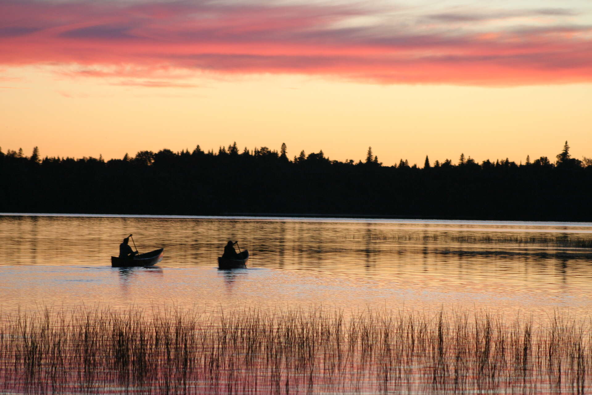 Canoe sur l'eau au coucher du soleil